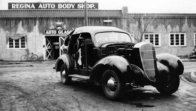 Vintage car with open hood at Regina Auto Body Shop in black and white photograph